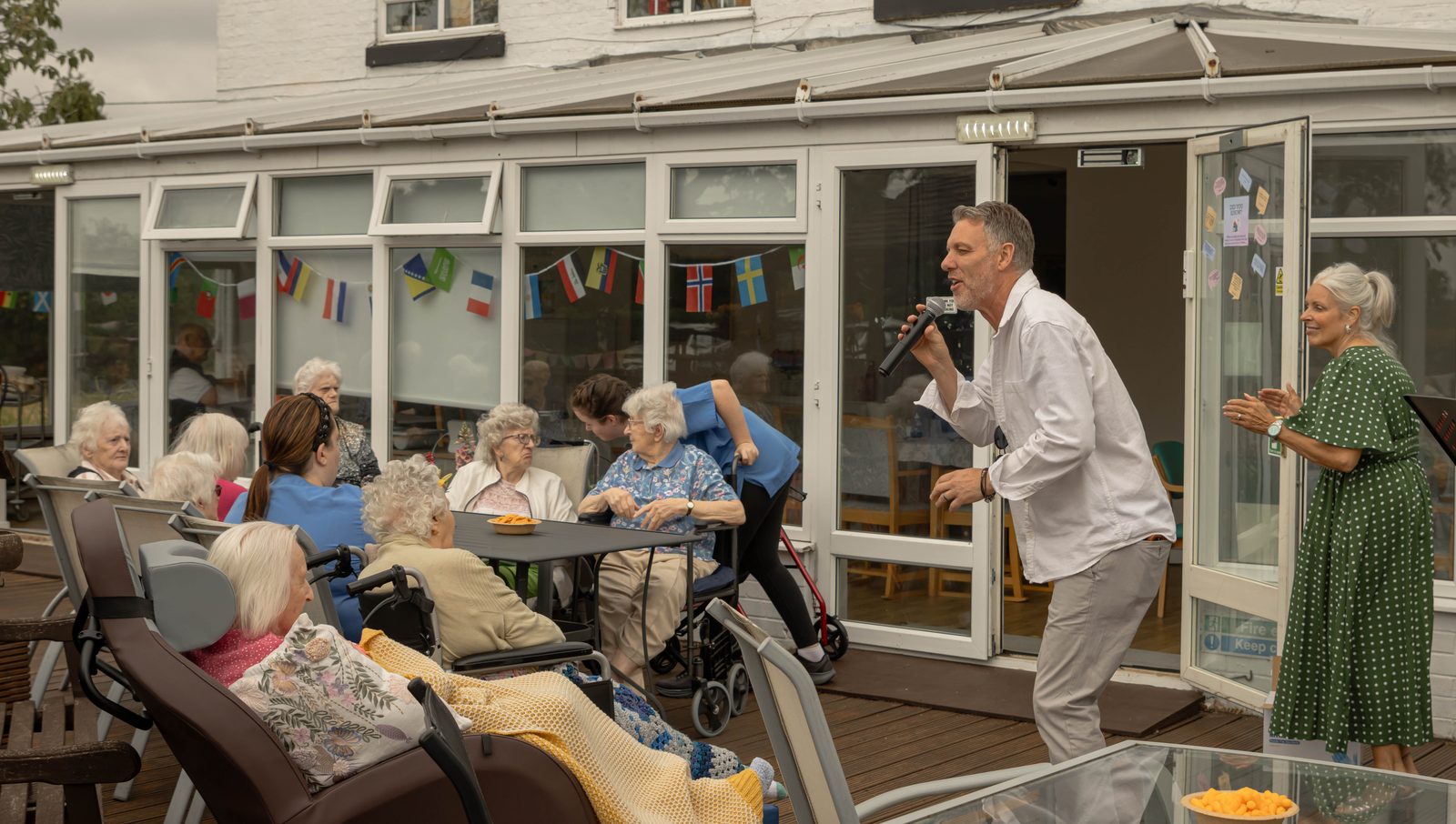 Residents and staff watching a singer perform