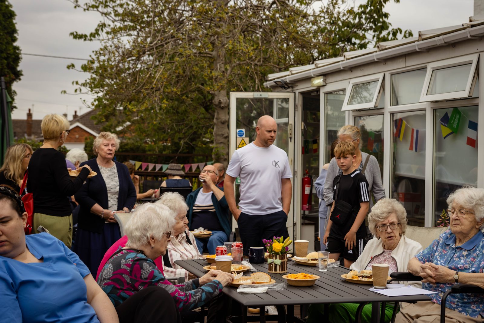 Residents and families eating together outside