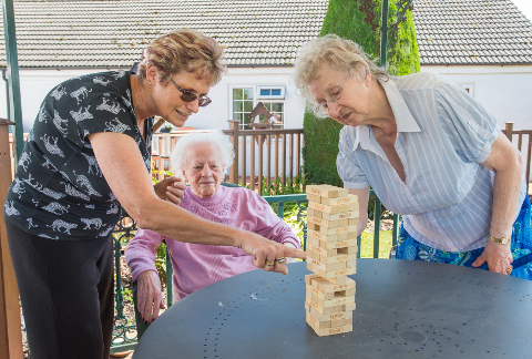 Residents playing giant Jenga on the patio